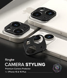 iPhone 15 Plus / 15 | Camera Styling - Black metal camera lens protectors applied to white iPhone 15 models.
