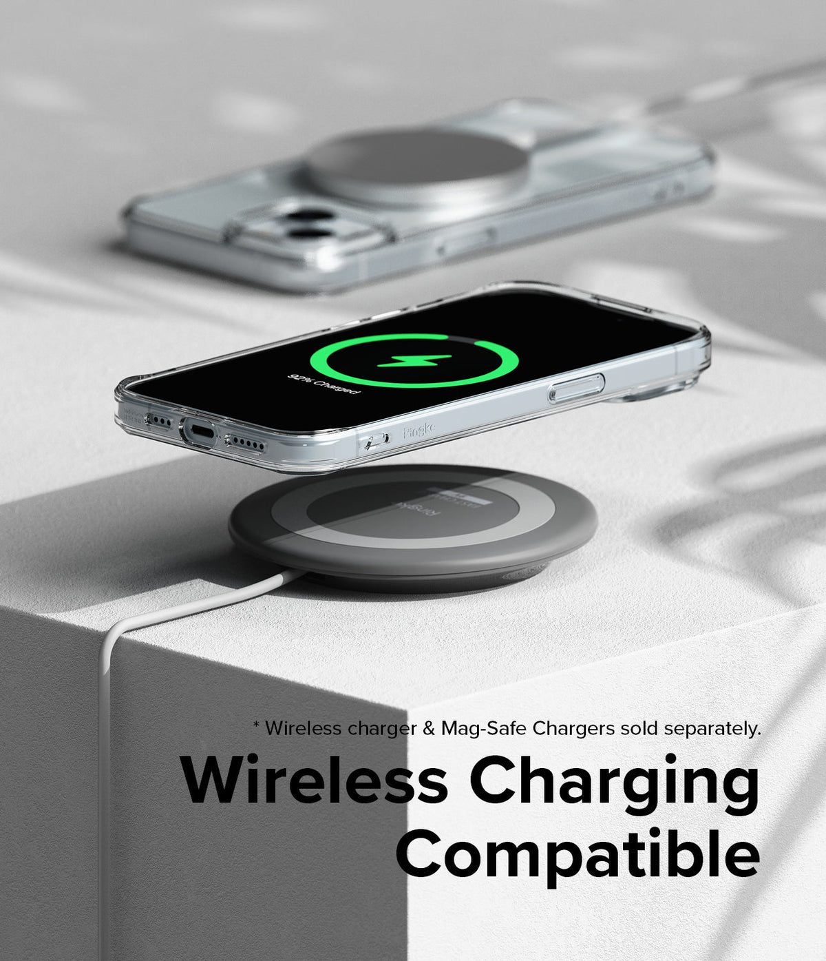 iPhone 15 Case | Fusion - Clear iPhone 15 case on a wireless charging pad showing a green charging icon on the screen.