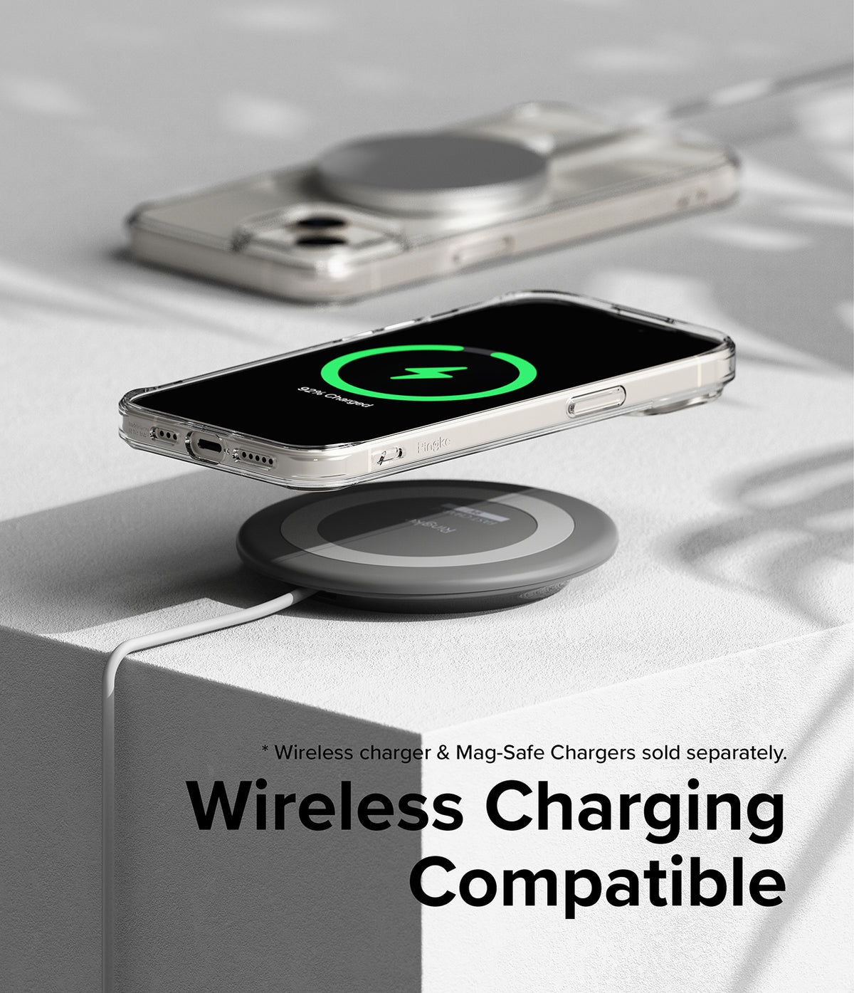 iPhone 15 Case | Fusion Magnetic - Clear phone case on a wireless charging pad showing a green charging indicator.