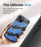 iPhone 15 Case | Onyx Design - Hand holding a blue and black brushstroke patterned phone case with non-slip micro-dot side grip.