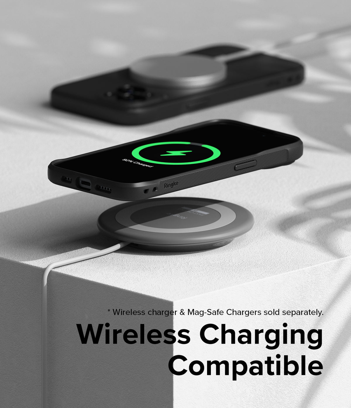 iPhone 15 Case | Onyx Magnetic - Black iPhone 15 in a magnetic case wirelessly charging on a circular pad.