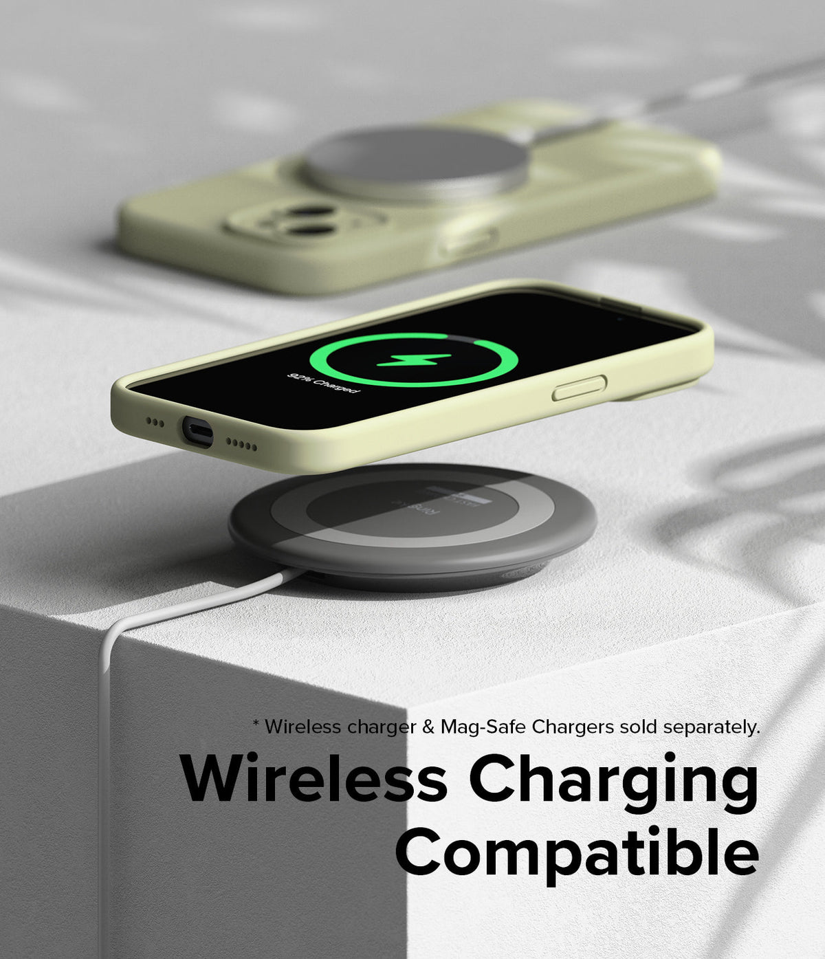 iPhone 15 Case | Silicone Magnetic - Pale yellow iPhone 15 case hovering above a wireless charging pad showing a charging icon.