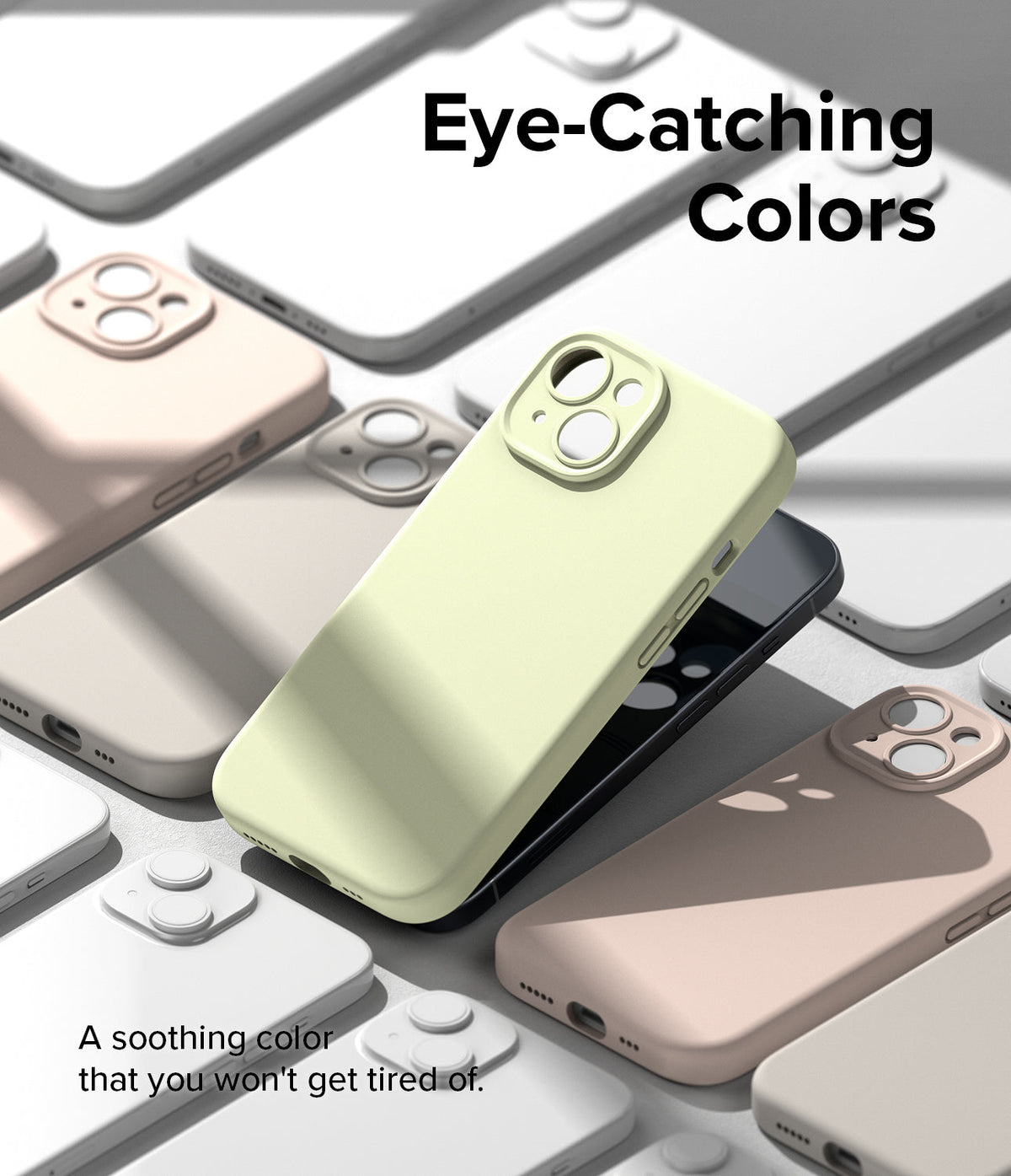 iPhone 15 Case | Silicone Magnetic - A light yellow iPhone 15 case surrounded by other pastel-colored cases on a gray surface.