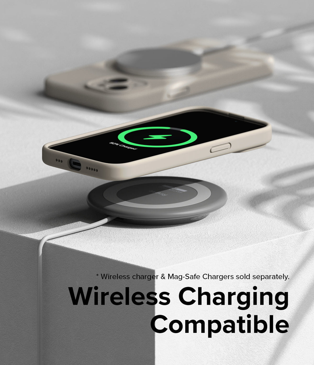 iPhone 15 Case | Silicone Magnetic - Beige iPhone 15 case hovering over a wireless charging pad showing a green charging icon.