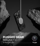 iPhone 16 Pro Max Case | Rugged Gear Magnetic - A rugged, camo-patterned phone case suspended by a magnetic charger between dark rocks.
