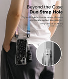 iPhone 16 Plus Case | Fusion Design - Person wearing a phone case with a colorful strap and accessory attached via duo holes.