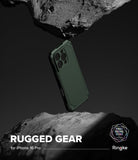 iPhone 16 Pro Case | Rugged Gear - A dark green rugged phone case floating between two jagged rocks against a dark background.