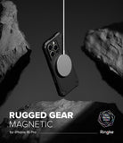 iPhone 16 Pro Case | Rugged Gear Magnetic - Black rugged phone case floating between rocks, attached to a magnetic charger.