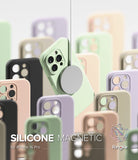 iPhone 16 Pro Case | Silicone Magnetic - A light green magnetic phone case suspended with a charger among pastel cases.
