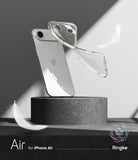 iPhone Air Case | Air - A clear, glittery phone case floating beside a silver iPhone on a stone pedestal with white feathers.