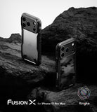 iPhone 17 Pro Max Case | Fusion-X - Two black Fusion-X phone cases displayed on dark, jagged rocks against a white background.