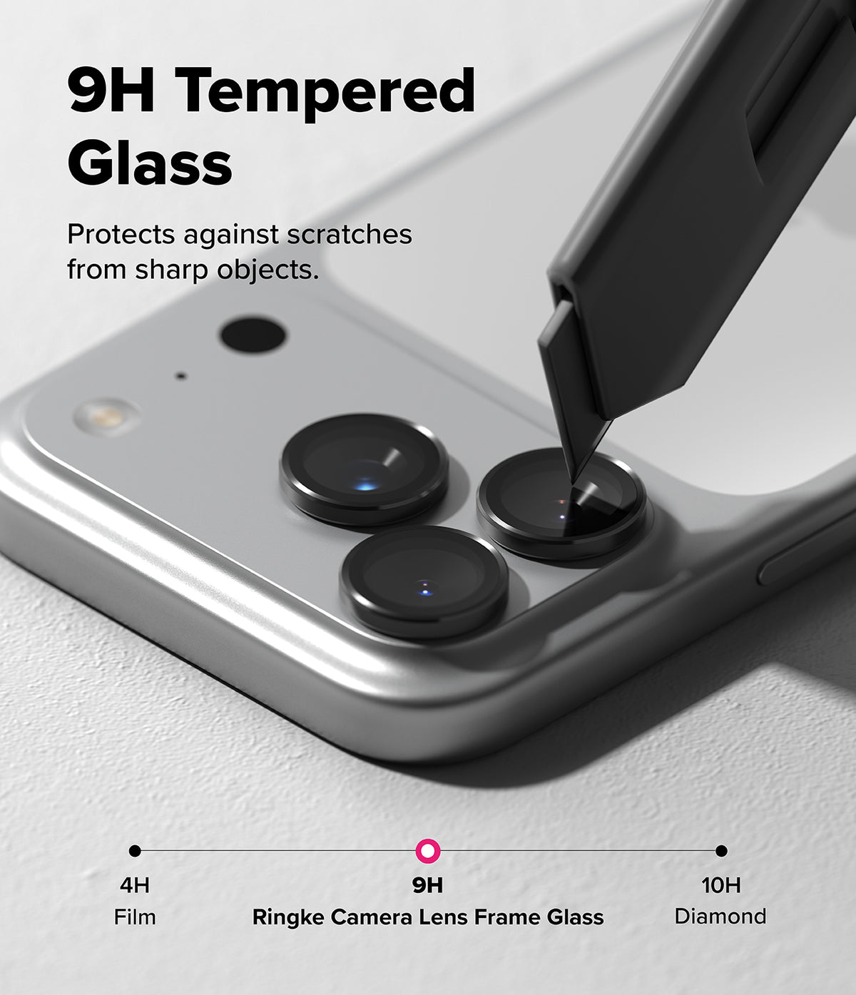 [Bundle] iPhone 17 Pro Max | Alles - iPhone 17 Pro Max - A utility knife blade presses against a 9H tempered glass camera lens protector on a smartphone.