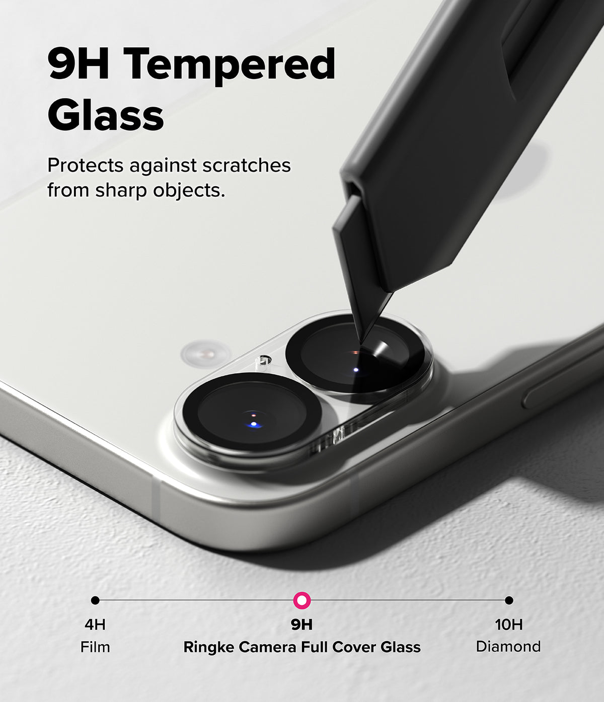 iPhone 17 | Camera Glass - A utility knife blade pressing against a 9H tempered glass camera lens protector on a smartphone.