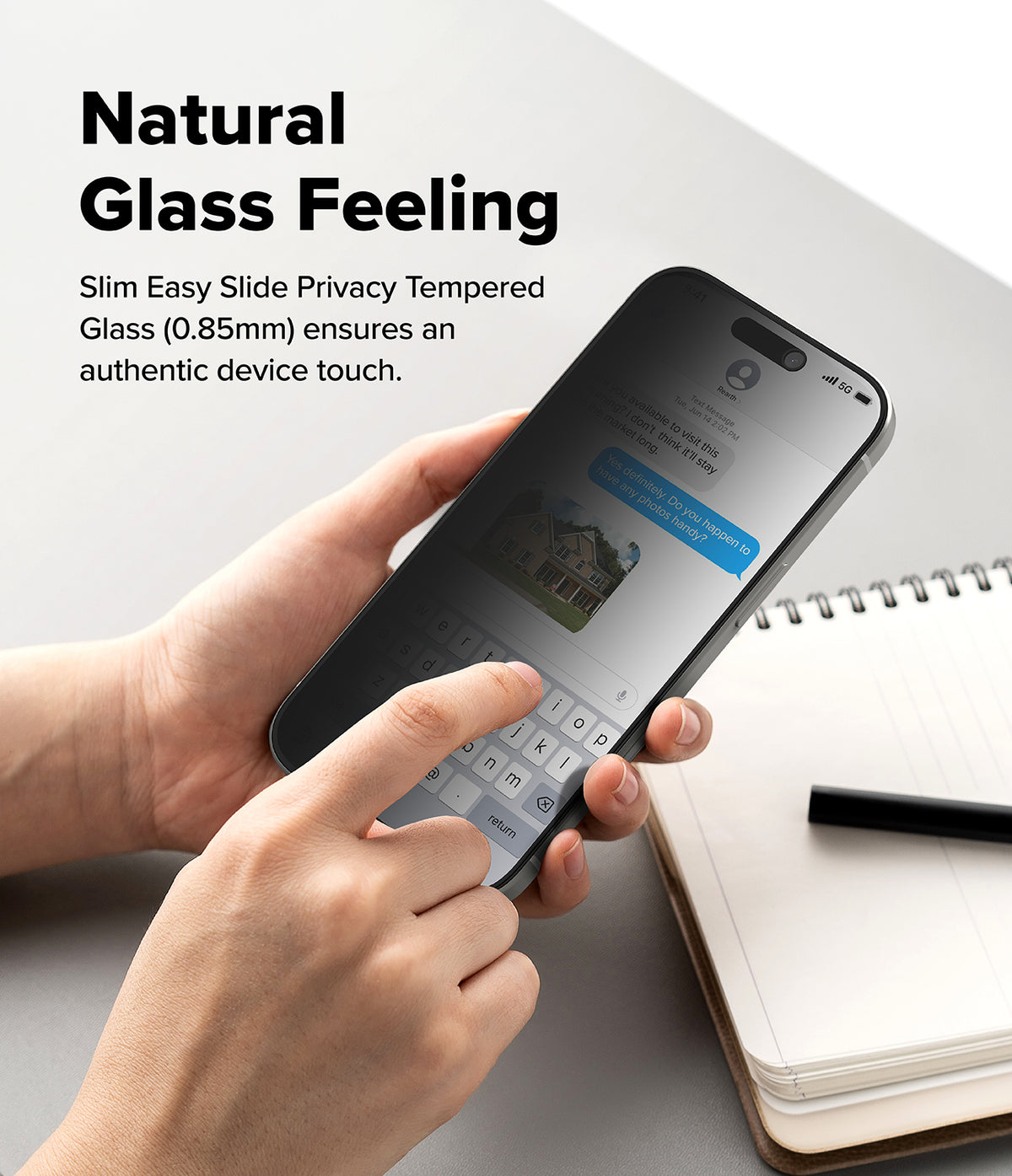 iPhone 17 Screen Protector | Easy Slide Privacy Tempered Glass - iPhone 17 Screen Protector - Hands holding a smartphone with a privacy screen protector while typing on the keyboard.
