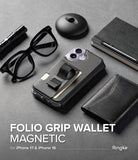 [Combo] iPhone 17 Cover | Folio Grip Wallet Magnetic + Fusion Magnetic - Black folio wallet case with finger strap on desk.