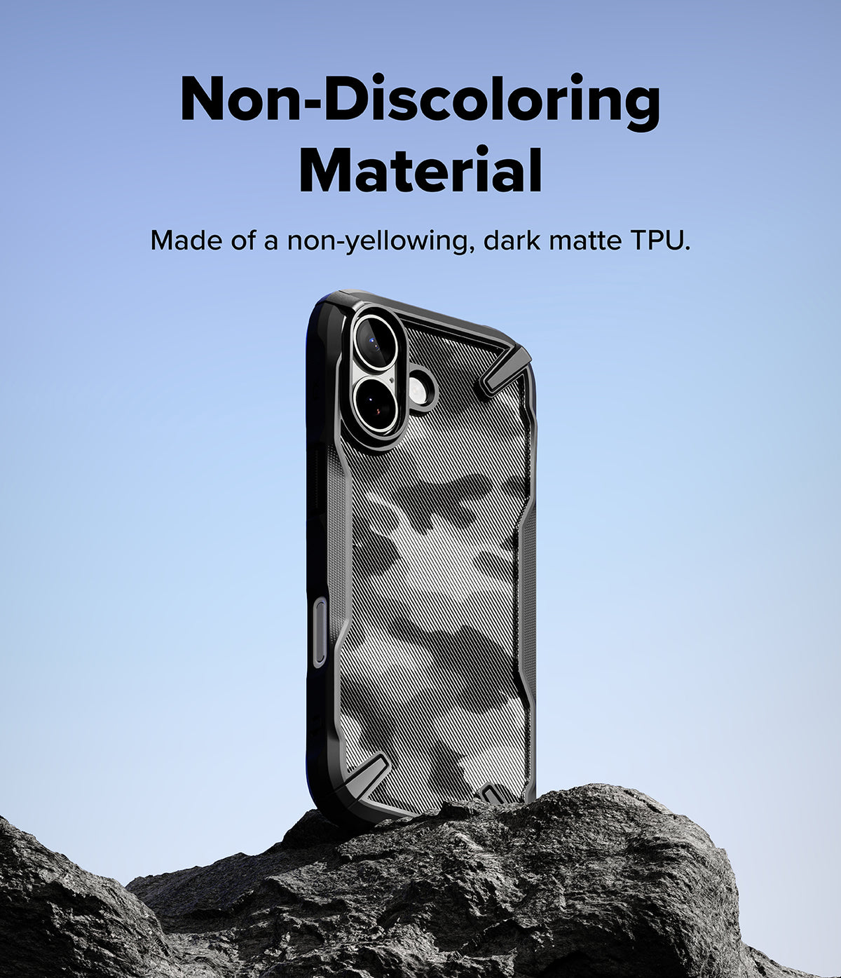iPhone 17 Case | Fusion-X - Black camouflage phone case standing on a rock against a blue sky background.