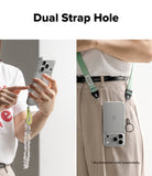 iPhone 18 Pro Max Case | Air - A promotional product image showing a clear phone case with a green adjustable shoulder strap and a dangling charm, demonstrated on a model. The left panel shows a close-up of hands holding the phone with the dangling charm, and the right panel shows the phone hanging from the waist strap.