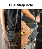 iPhone 18 Pro Max Case | Onyx - A phone case with a dark camouflage pattern is shown in two lifestyle contexts, demonstrating a dual strap design. On the left, a person wears the case on their hip with a black strap.