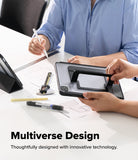 Ringke Apple iPad Pro (11") / Air (11", 10.9") Case [Multiverse Case] - A person holds a black tablet in a stand at a white desk, with another person in a blue shirt writing nearby. The image includes the text 'Multiverse Design' and 'Thoughtfully designed with innovative technology.