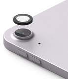 Camera Lens Frame Glass | iPad - A protective black lens cover hovering above the rear camera of a light purple tablet.