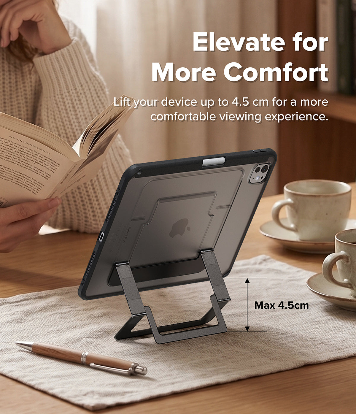 Ringke Apple iPad Pro (11") / Air (11", 10.9") Case [Multiverse Case] - A dark gray tablet stand shown in a home office setting, holding a tablet upright on a desk. The scene includes a person reading in the background, coffee cups, and text overlays explaining the stand's height feature ('Elevate for More Comfort', 'Max 4.