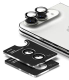 iPhone Duo Camera Protector | Camera Lens Frame Glass (2 Pack) - Three black camera lens frame protectors with silver edges are shown, with two stacked on a phone and one displayed separately. The phone has a silver Apple logo visible on the back.