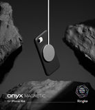 iPhone 16e Case | Onyx Magnetic - A black magnetic phone case suspended by a charging puck between dark, textured rocks.