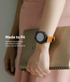 Watch Lug 20mm | Leather One Classic Band - Person wearing a black smartwatch with a tan leather strap holding a notebook.