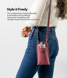 Mini Cross Bag | PU Leather - Mini Cross Bag - A person wearing a burgundy PU leather phone crossbody bag with an adjustable strap over jeans.