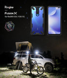Redmi K30 Case | Fusion-X - Redmi K30 phone in a black Fusion-X case shown against a starry night sky and outdoor camping scene.