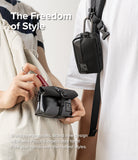 Mini Pouch Tarpaulin | Roll Top - Person placing lipstick into a black roll-top pouch while another wears a matching pouch.
