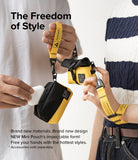 Mini Pouch Tarpaulin | Roll Top - Two people holding yellow and black roll-top pouches with industrial-style wrist straps.