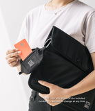 Mini Pouch | Sling Bag - Person holding a black mini pouch attached to a sling bag, inserting an orange credit card.