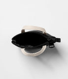 Mini Pouch | Tote Bag - Top-down view of an open black mini tote bag with beige handles and a black zipper on a white background.