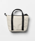 Mini Pouch | Tote Bag - A small, off-white canvas pouch with black handles and a top zipper, shaped like a miniature tote.
