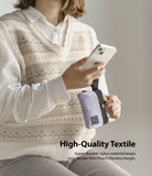 Mini Pouch | 2-Way Bag Miniature - Person holding a smartphone and a small, lavender nylon pouch with a black strap.
