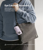 Mini Pouch | 2-Way Bag Miniature - Mini Pouch - A person wearing a blue hoodie with a small lavender pouch clipped to a larger dark grey shoulder bag.