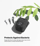 Mini Pouch | Block - Black textured mini pouch with a branded label, positioned under a green leaf on a white background.