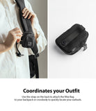 Mini Pouch | Block - Black mini pouch attached to a backpack strap and shown isolated on a white background.