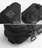 Mini Pouch | Block - Close-up of black fabric pouch showing product label, connector strap, and zipper details.