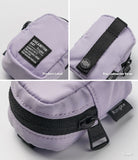 Mini Pouch | Block - Close-up of a lavender pouch showing the product label, black connector strap, and branded zipper.