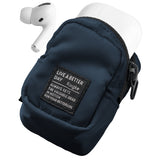 Mini Pouch | Block - Navy blue fabric pouch with a branded patch, holding white wireless earbuds and their charging case.
