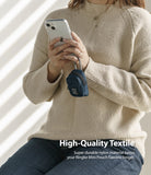 Mini Pouch | Block - Person holding a phone with a small navy blue nylon pouch clipped to their finger via a carabiner.