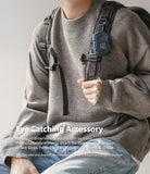 Mini Pouch | Block - A small navy blue pouch clipped to a backpack strap, worn by a person in a grey sweater and jeans.