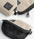 Mini Pouch | Half-Pocket - Close-up views of beige pouch showing branded label, black zipper pull, and soft black interior lining.