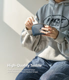 Mini Pouch | Half-Pocket - Person in a grey hoodie placing white wireless earbuds into a small blue nylon zippered pouch.