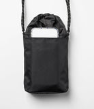 Mini Cross Bag | Bucket Bag - Black drawstring bucket bag with a smartphone tucked into the front pocket and a patterned strap.