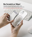 Card Holder | Magnetic Slot - Hands attaching a magnetic card holder to a clear phone case above a computer keyboard.