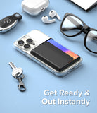 Card Holder | Magnetic Side Slot - Black magnetic card holder attached to a clear iPhone case on a blue surface with accessories.
