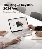 MacBook Neo | Keyskin - A promotional graphic for The Ringke Keyskin 2026 Ver., showing a white table with a laptop displaying a webpage about the brand's 2003 Keyskin, surrounded by hands holding papers and writing in a notebook in a bright office setting.